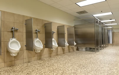 Image of a bathroom in a commercial setting with urinals and stalls 