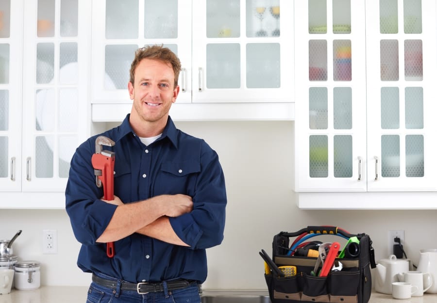 Image of a man holding a wrench