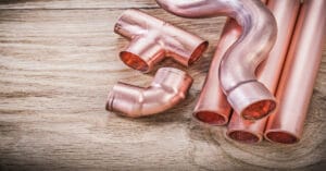 A collection of copper pipe pieces as a cover photo for blog "Plumbing Myths Busted Part 3"